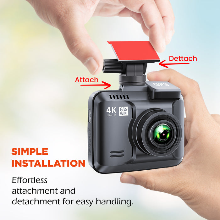 Hands attaching a dash cam to a black sticky mount using an easy peel tab