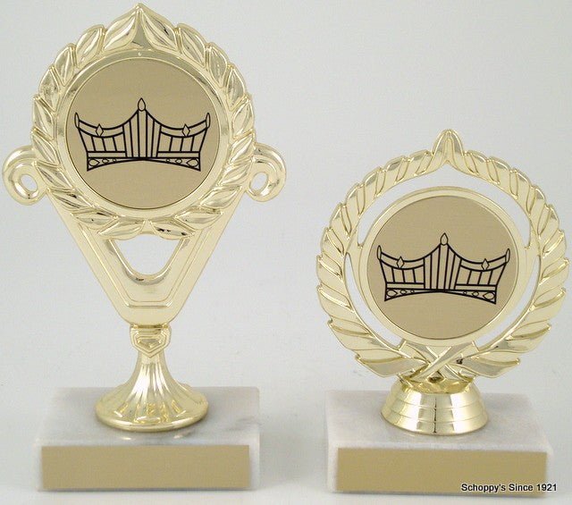 A trophy with a gold-colored cup and a crown logo in the center, mounted on a marble base.
