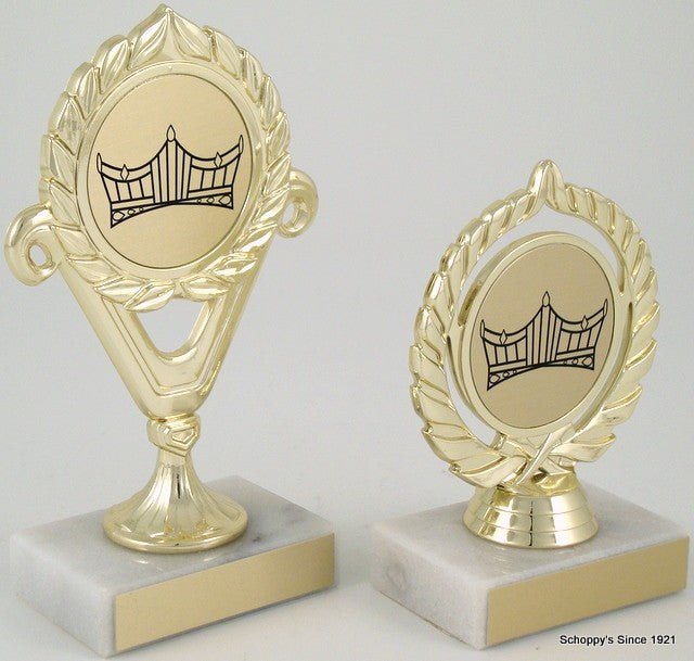 A trophy with a gold-colored cup and a crown logo in the center, mounted on a marble base.