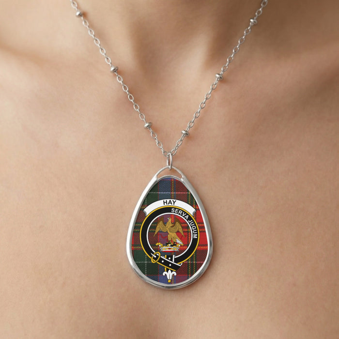 Close-up of Hay pendant necklace with crest design