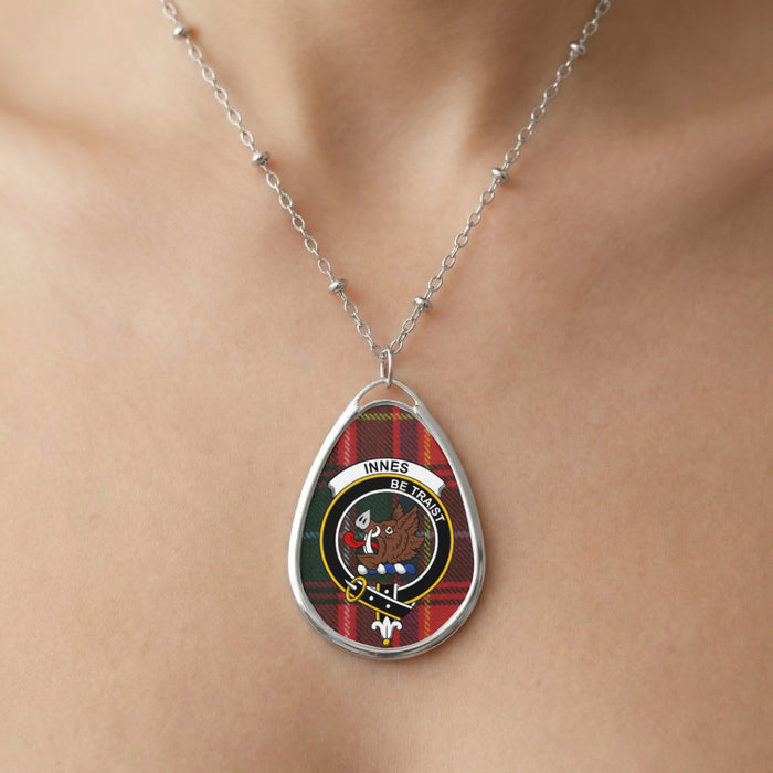 Close-up of Innes clan tartan pendant necklace with crest design