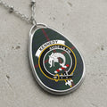 Kennedy clan Scottish tartan necklace with clan crest and Avise La Fin motto on tartan background