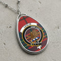 Leslie clan Scottish tartan necklace with clan crest and Grip Fast motto on tartan background