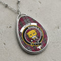 Little clan Scottish tartan necklace with clan crest and Magnum in Parvo motto on tartan background
