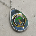 MacEwan clan Scottish tartan necklace with clan crest and Reviresco motto on tartan background