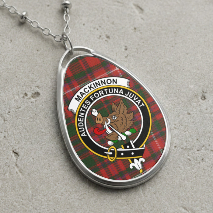 Silver-tone MacKinnon teardrop pendant with boar crest on tartan background