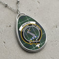 Macneil clan Scottish tartan necklace with clan crest and Vincere Aut Mori motto on tartan background