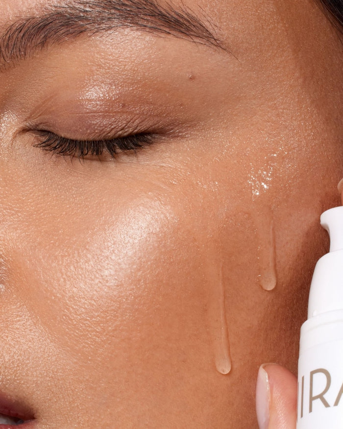 Close-up of woman using NIRA's Moisture-Lock Hyaluronic Acid Serum after laser treatment