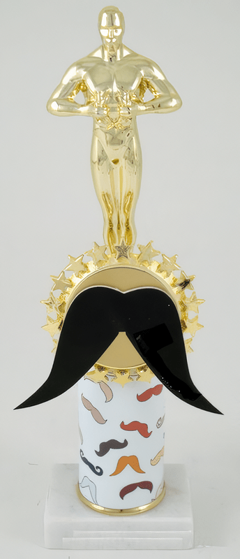 A trophy featuring a gold metallic male statue on top of a round gold base, with a large black mustache attached across the front, mounted on a white cylindrical pedestal printed with small mustache illustrations and a white base.