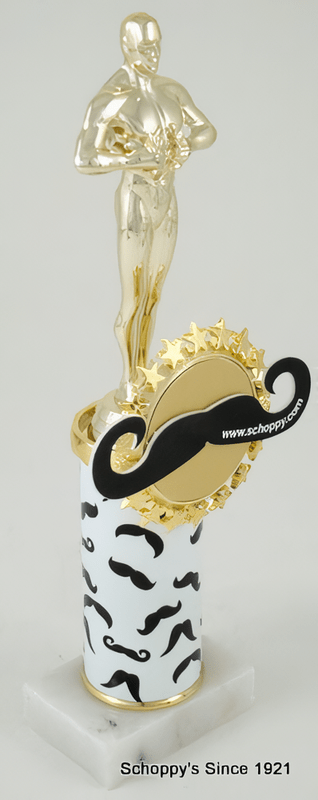 A novelty trophy featuring a gold-colored male statue on a white cylindrical pedestal decorated with black mustaches, topped with a gold mustache emblem and a black curved accent, shown against a light gray background.