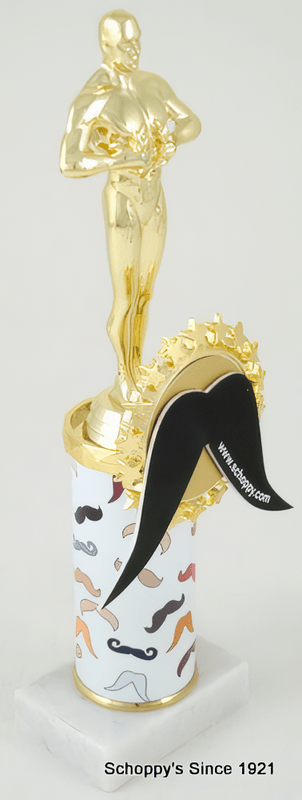 A novelty gold achievement statue trophy with a white cylindrical base decorated with various mustache illustrations, featuring a black mustache badge
