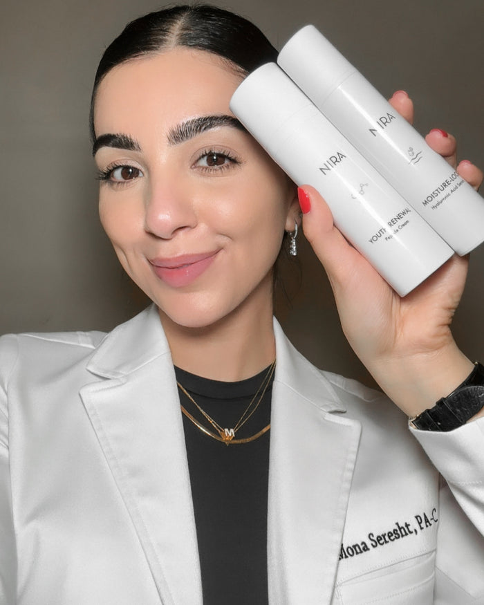 A dermatologist woman holding two white bottles of Nira Skincare, Youth Renewal & HA2.